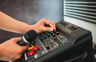 Sound engineer hands adjusting control sound mixer in recording, broadcasting studio,Sound mixer. Professional audio mixing console, buttons, faders and sliders. sound check. photo