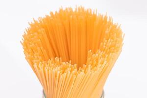 Dry Uncooked Spaghetti Isolated on White Background - Close-Up. Raw Pasta - Isolation photo
