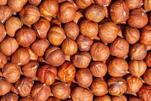 Scattered Peeled Hazelnut - Top View. Background from Hazelnuts. Natural High-Calorie Snacks photo