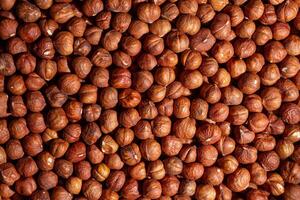 Scattered Peeled Hazelnut - Top View. Background from Hazelnuts. Natural High-Calorie Snacks photo