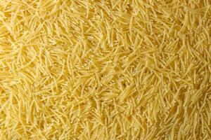 Uncooked Filini Pasta. A Culinary Canvas of Noodles, Creating a Lively and Textured Background for Gourmet Cooking. Dry Pasta. Raw Macaroni - Top View, Flat Lay photo