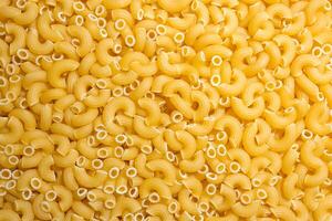 Uncooked Chifferi Rigati Pasta. A Culinary Canvas of Chifferi Rigati, Creating a Lively and Textured Background for Gourmet Cooking. Dry Pasta. Raw Macaroni - Top View, Flat Lay photo