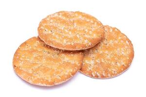 A Heap of Round Salt Crackers with Sesame Isolated on White Background. Dry Snacks - Isolation photo