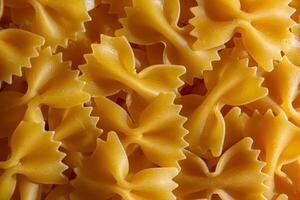 Uncooked Farfalle Pasta. A Culinary Canvas of Bow-Tie Macaroni, Creating a Lively and Textured Background for Gourmet Cooking. Dry Pasta. Raw Macaroni - Top View, Flat Lay photo