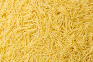 Uncooked Filini Pasta. A Culinary Canvas of Noodles, Creating a Lively and Textured Background for Gourmet Cooking. Dry Pasta. Raw Macaroni - Top View, Flat Lay photo