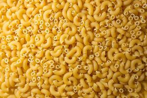 Uncooked Chifferi Rigati Pasta. A Culinary Canvas of Chifferi Rigati, Creating a Lively and Textured Background for Gourmet Cooking. Dry Pasta. Raw Macaroni - Top View, Flat Lay photo