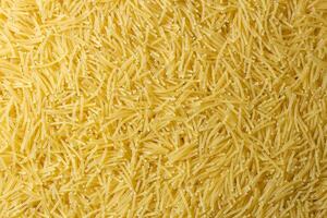 Uncooked Filini Pasta. A Culinary Canvas of Noodles, Creating a Lively and Textured Background for Gourmet Cooking. Dry Pasta. Raw Macaroni - Top View, Flat Lay photo