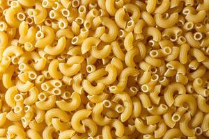 Uncooked Chifferi Rigati Pasta. A Culinary Canvas of Chifferi Rigati, Creating a Lively and Textured Background for Gourmet Cooking. Dry Pasta. Raw Macaroni - Top View, Flat Lay photo