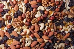 Mixed Nuts. Almonds, Walnuts, Cashews, Peanuts, Hazelnuts, Dried Prunes and Raisins. Different Nut Mix. Background from Various Nuts and Dried Fruits photo