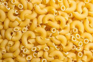 Uncooked Chifferi Rigati Pasta. A Culinary Canvas of Chifferi Rigati, Creating a Lively and Textured Background for Gourmet Cooking. Dry Pasta. Raw Macaroni - Top View, Flat Lay photo