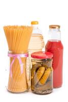 Food Reserves. Canned Food, Spaghetti, Pickles and Tomato Juice - Isolated on White Background. Emergency Food Storage in Case of Crisis. Strategic Food Supplies - Isolation photo