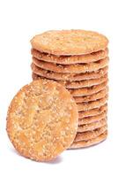 A Stack of Round Salt Crackers with Sesame Isolated on White Background. Dry Snacks - Isolation photo
