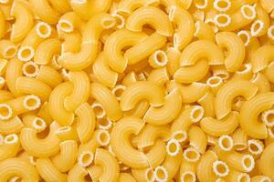 Uncooked Chifferi Rigati Pasta. A Culinary Canvas of Chifferi Rigati, Creating a Lively and Textured Background for Gourmet Cooking. Dry Pasta. Raw Macaroni - Top View, Flat Lay photo