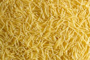 Uncooked Filini Pasta. A Culinary Canvas of Noodles, Creating a Lively and Textured Background for Gourmet Cooking. Dry Pasta. Raw Macaroni - Top View, Flat Lay photo