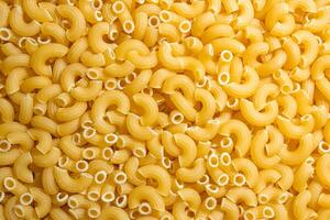 Uncooked Chifferi Rigati Pasta. A Culinary Canvas of Chifferi Rigati, Creating a Lively and Textured Background for Gourmet Cooking. Dry Pasta. Raw Macaroni - Top View, Flat Lay photo