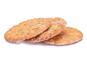 A Heap of Round Salt Crackers with Sesame Isolated on White Background. Dry Snacks - Isolation photo