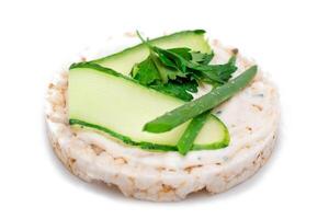 Vegan Rice Cake Sandwich with Fresh Cucumber and Greens - Isolated on White Background. Vegetarian Diet Food. Quick and Healthy Sandwiches. Crispbread with Fresh Fillings. Dietary Snack photo