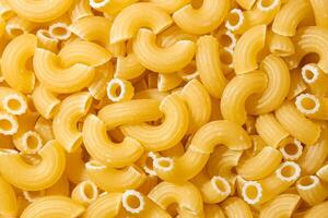 Uncooked Chifferi Rigati Pasta. A Culinary Canvas of Chifferi Rigati, Creating a Lively and Textured Background for Gourmet Cooking. Dry Pasta. Raw Macaroni - Top View, Flat Lay photo