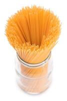 Dry Uncooked Spaghetti in a Glass Jar Isolated on White Background. Raw Pasta - Isolation photo