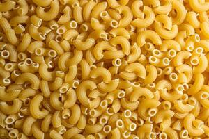 Uncooked Chifferi Rigati Pasta. A Culinary Canvas of Chifferi Rigati, Creating a Lively and Textured Background for Gourmet Cooking. Dry Pasta. Raw Macaroni - Top View, Flat Lay photo