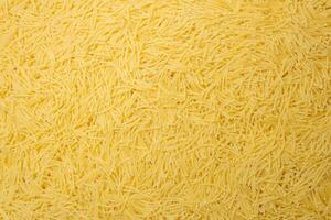 Uncooked Filini Pasta. A Culinary Canvas of Noodles, Creating a Lively and Textured Background for Gourmet Cooking. Dry Pasta. Raw Macaroni - Top View, Flat Lay photo