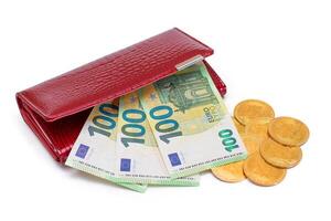 Opened Red Leather Women Purse with Bitcoin Coins and One Hundred Euro Banknotes Inside - Isolated on White Background. A Wallet Full of Money Symbolizing Wealth, Success and Social Status - Isolation photo