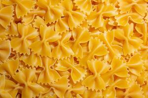 Uncooked Farfalle Pasta. A Culinary Canvas of Bow-Tie Macaroni, Creating a Lively and Textured Background for Gourmet Cooking. Dry Pasta. Raw Macaroni - Top View, Flat Lay photo