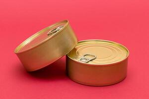 A Group of Stacked Tin Cans with Blank Edges on Red Background. Canned Food. Different Aluminum Cans for Safe and Long Term Storage of Food. Steel Sealed Food Storage Containers photo