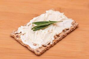 Whole Grain Crispbread with Cream Cheese on Bamboo Cutting Board. Quick and Healthy Sandwiches. Healthy Dietary Snack photo