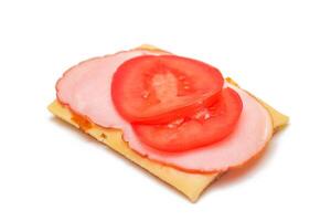 Whole Grain Crispbread with Tomato, Ham and Cheese - Isolated on White. Easy Breakfast. Quick and Healthy Sandwiches. Crispbread with Tasty Filling. Healthy Dietary Snack - Isolation photo