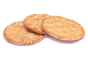 A Heap of Round Salt Crackers with Sesame Isolated on White Background. Dry Snacks - Isolation photo