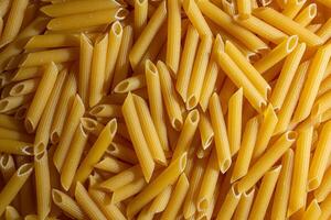 Uncooked Penne Rigate Pasta. A Culinary Canvas of Penne Macaroni, Creating a Lively and Textured Background for Gourmet Cooking. Dry Pasta. Raw Macaroni - Top View, Flat Lay photo
