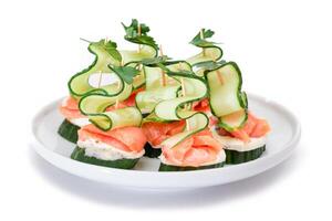 Canapes without Bread with Fresh Salmon, Cucumber and Cream Cheese - Isolated on White Background. Easy Breakfast. Diet Food. Quick and Healthy Sandwiches. Healthy Snacks with Tasty Fillings photo