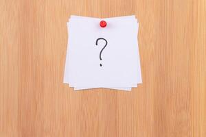 White Sticky Notes with Question Mark Pinned to the Wooden Message Board. To Do List Reminder in the Office. Memo Note at Work photo
