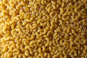 Uncooked Chifferi Rigati Pasta. A Culinary Canvas of Chifferi Rigati, Creating a Lively and Textured Background for Gourmet Cooking. Dry Pasta. Raw Macaroni - Top View, Flat Lay photo