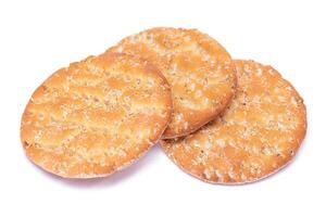 A Heap of Round Salt Crackers with Sesame Isolated on White Background. Dry Snacks - Isolation photo