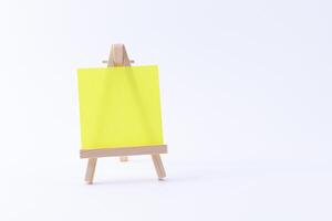 Wooden Easel Miniature with Blank Colored Square Canvas or Memo Paper - Mockup. Mini Wooden Stand with Clean Artboard on White Background, Copy Space photo
