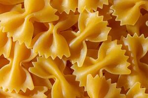 Uncooked Farfalle Pasta. A Culinary Canvas of Bow-Tie Macaroni, Creating a Lively and Textured Background for Gourmet Cooking. Dry Pasta. Raw Macaroni - Top View, Flat Lay photo