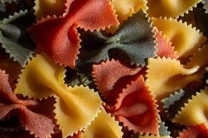 Uncooked Vibrant Colored Farfalle Pasta. A Culinary Canvas of Multicolored Bow-Tie Macaroni, Creating a Lively and Textured Background for Gourmet Cooking Enthusiasts. Colored Dry Pasta. Raw Macaroni photo