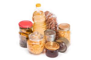Food Reserves. Canned Food, Spaghetti, Pate, Tuna, Tomato Juice, Pasta, Fish and Grocery - Isolated on White Background. Emergency Food Storage in Case of Crisis. Strategic Food Supplies - Isolation photo