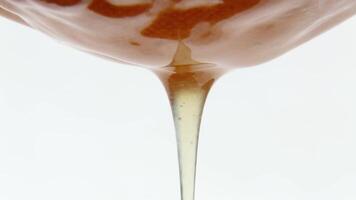 An incessant stream of liquid, fresh honey flows slowly against Macro. Asmr. video