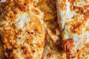 cooked chicken chops on white plate on table close up photo