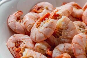 Boiled king prawns in a deep bowl with lemon photo