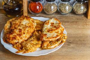 cooked chicken chops on a white plate on the table photo