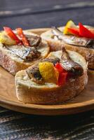 fish sandwich with butter and sprats lemon and red pepper photo