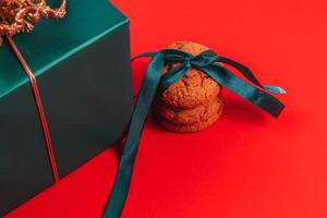 Green gift box with cookies with ribbon photo
