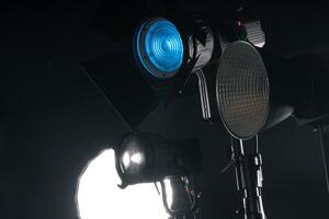 Studio Lighting Setup for a Creative Photo Shoot With Various Light Sources in a Dark Environment
