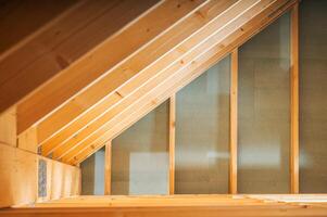 Wooden Rafters and Beams in an Unfinished Attic During Daylight Highlight Construction Progress photo
