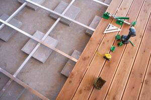 Building a Wooden Deck With Tools and Materials Laid out in Preparation on a Sunny Day photo