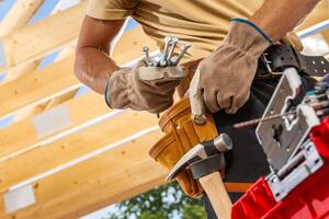 Skilled Carpenter Organizing Tools in a Workshop While Preparing for a Project on a Sunny Day photo